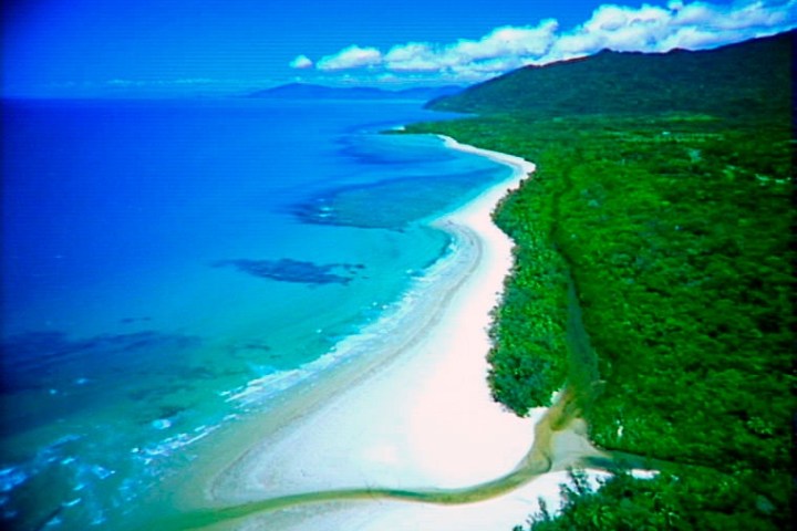 a large body of water with Cape Tribulation, Queensland in the background