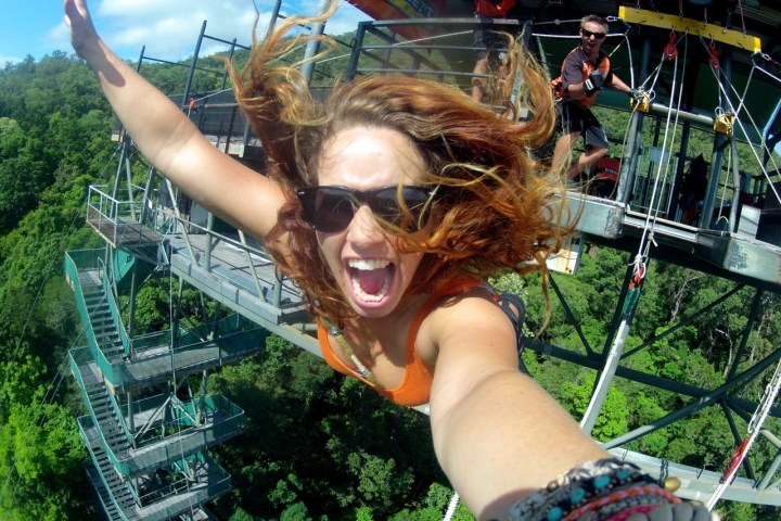 a woman wearing sunglasses posing for the camera