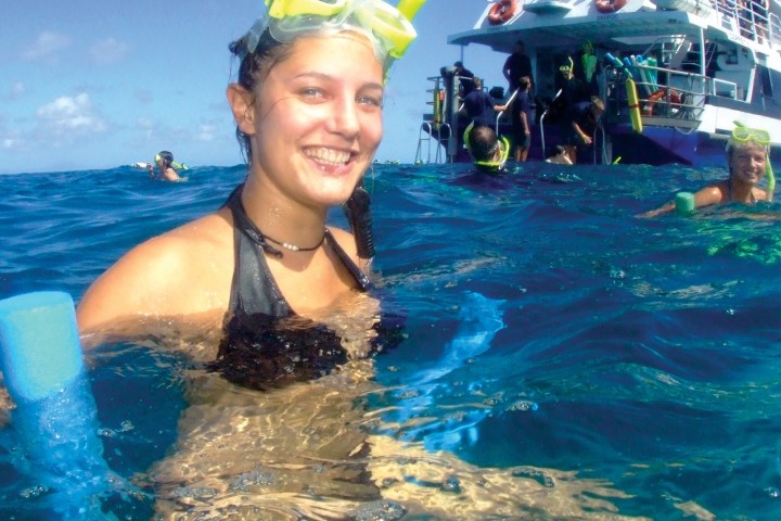 a person standing next to a body of water